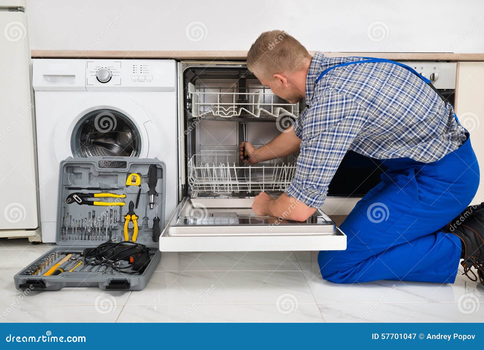 Man Repairing Dishwasher stock image. Image of safety 57701047