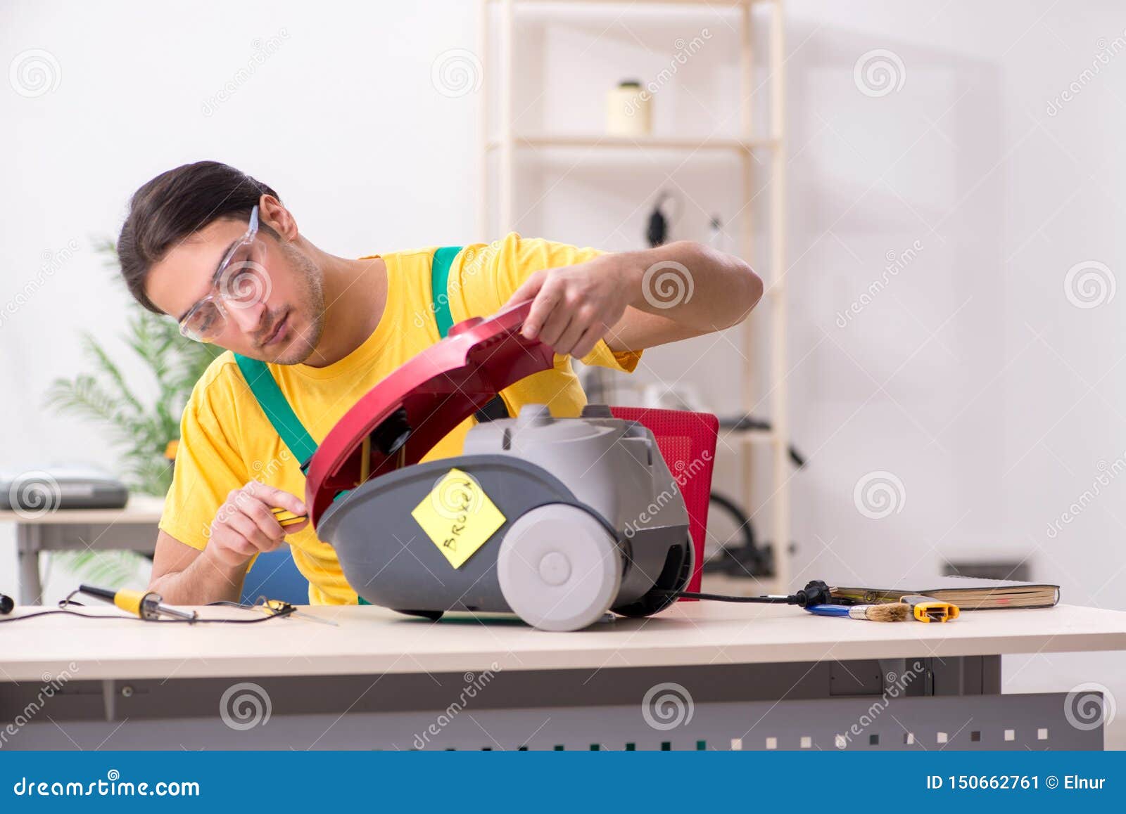 The Man Repairman Repairing Vacuum Cleaner Stock Image