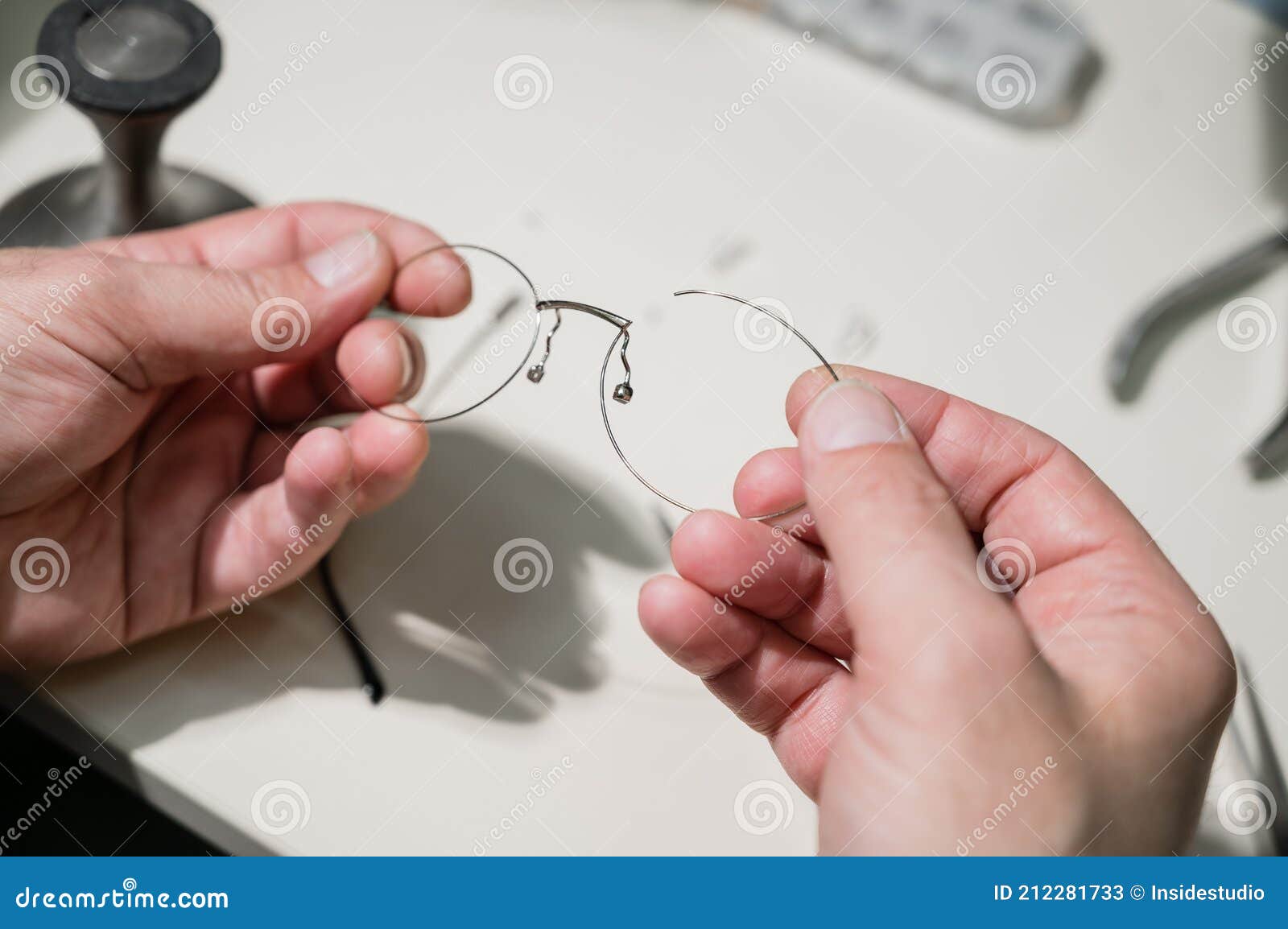 A Man Repairs a Broken Eyeglass Frame. Closeup of the Ophthalmologist