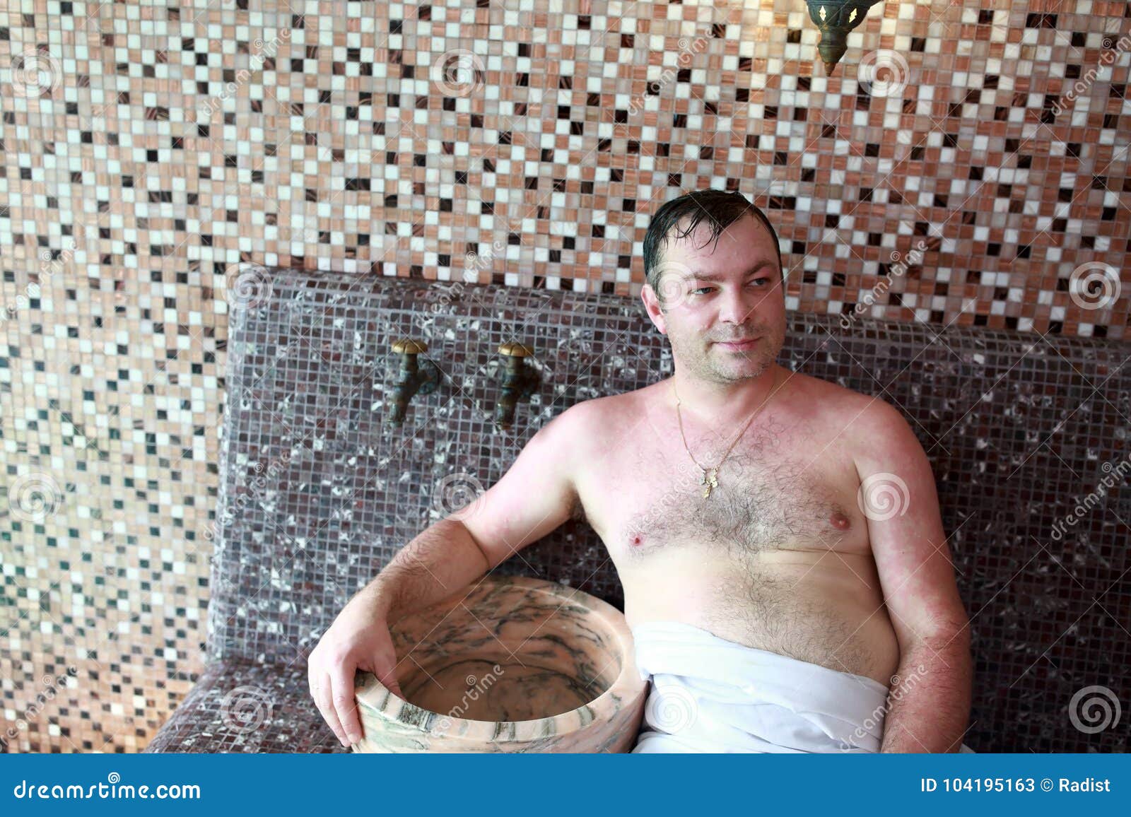 Man on bench in hammam stock image. Image of bathhouse - 104195163