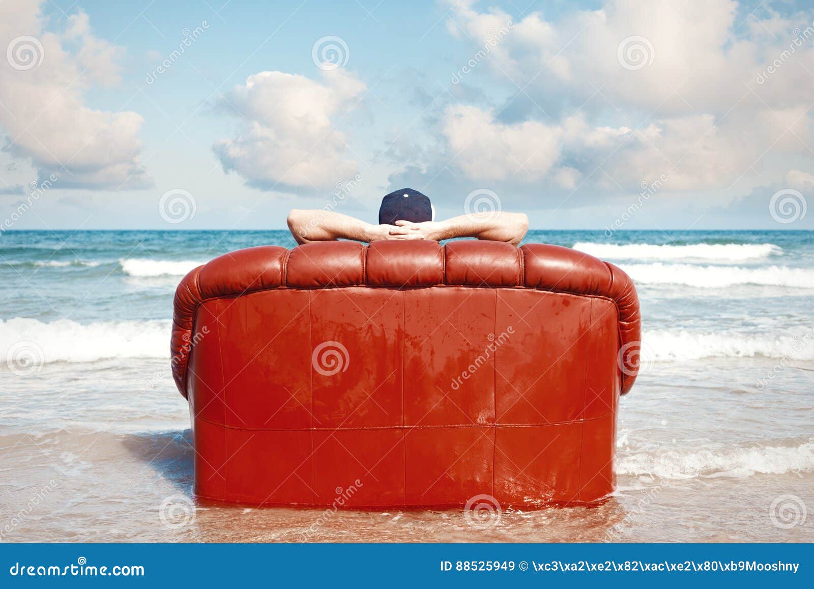 man resting in couch on the beach
