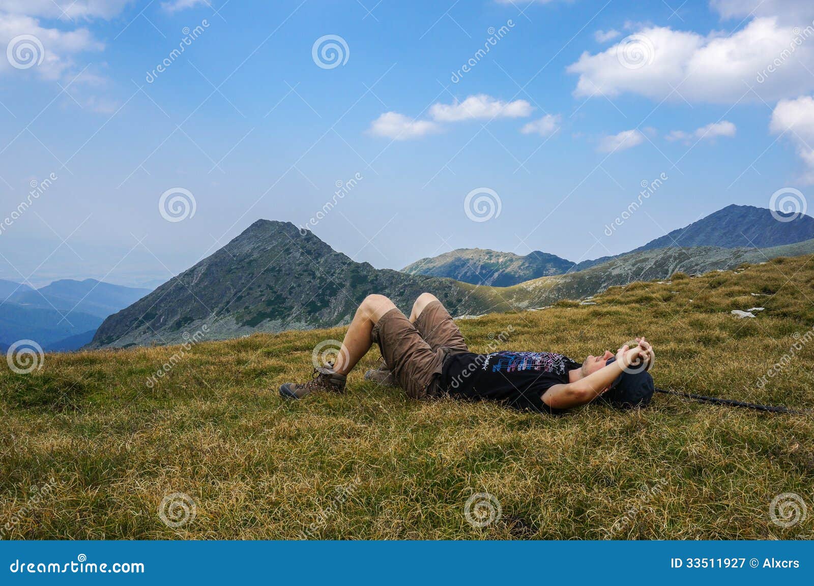 Man Resting on the Grass in the Mountains Stock Image Image of laying, lying 33511927