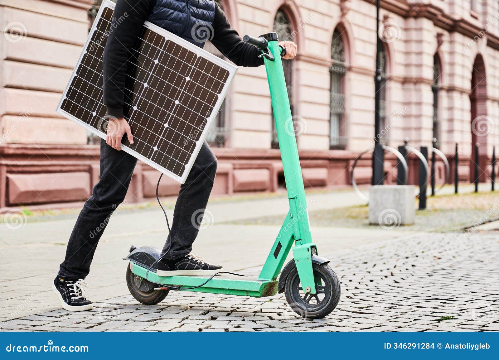 man rides electric scooter with solar panel. integration of solar power sustainable energy source.