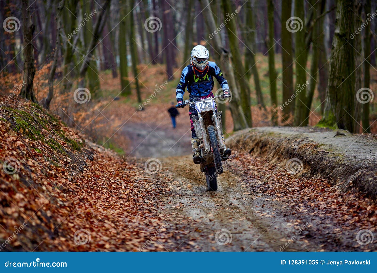 Man Riding A Motorcycle Fast In Autumn Forest. Blurred