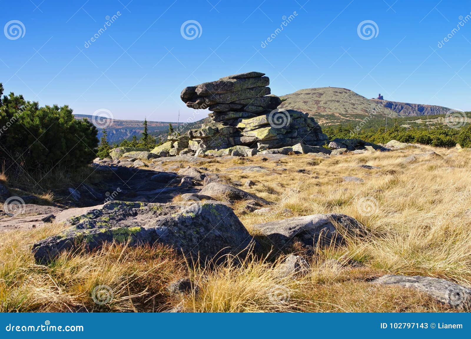 man rocks in giant mountains