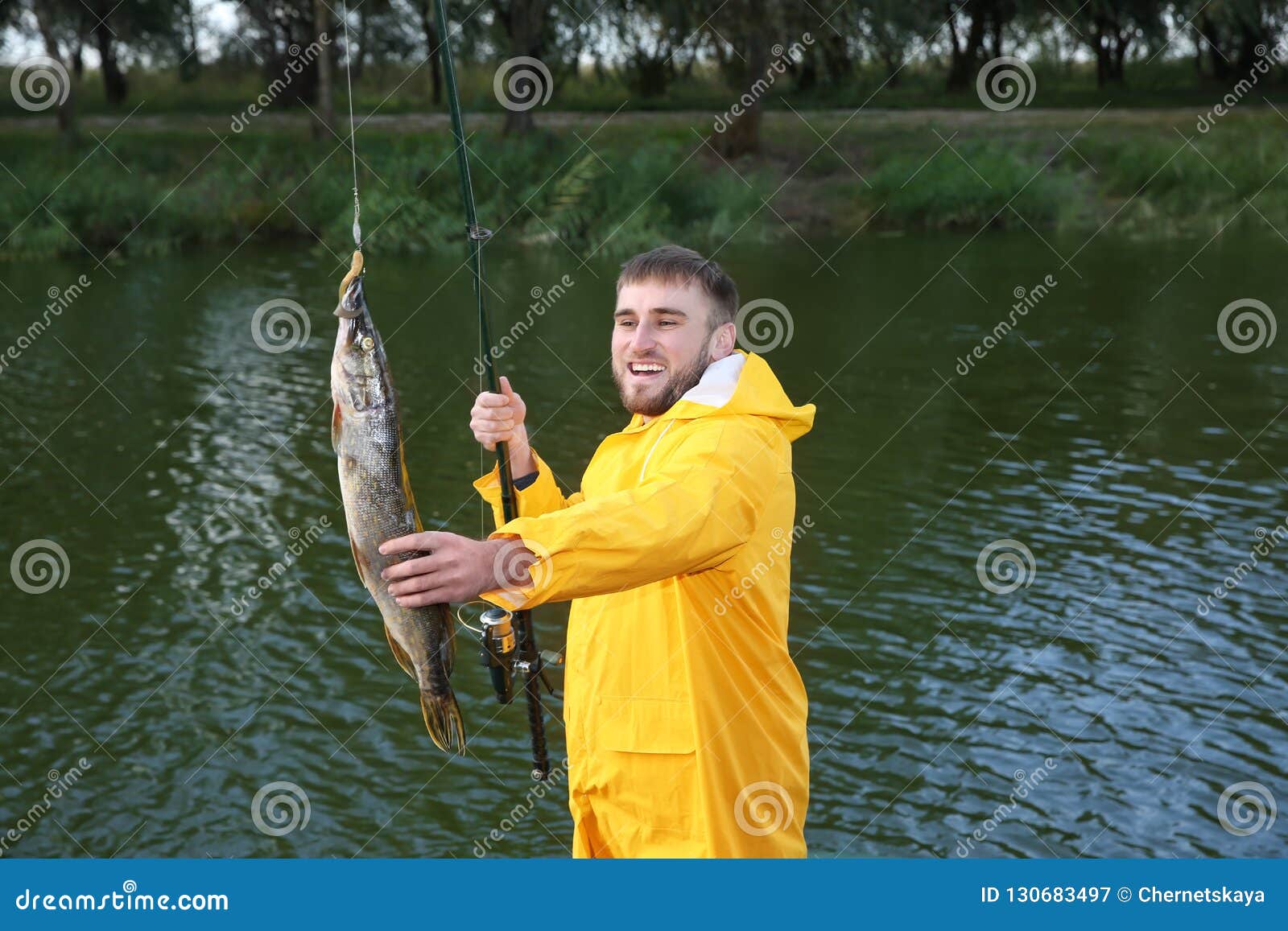 Man with Rod and Catch Fishing at Riverside Stock Image - Image of pond,  freshwater: 130683497