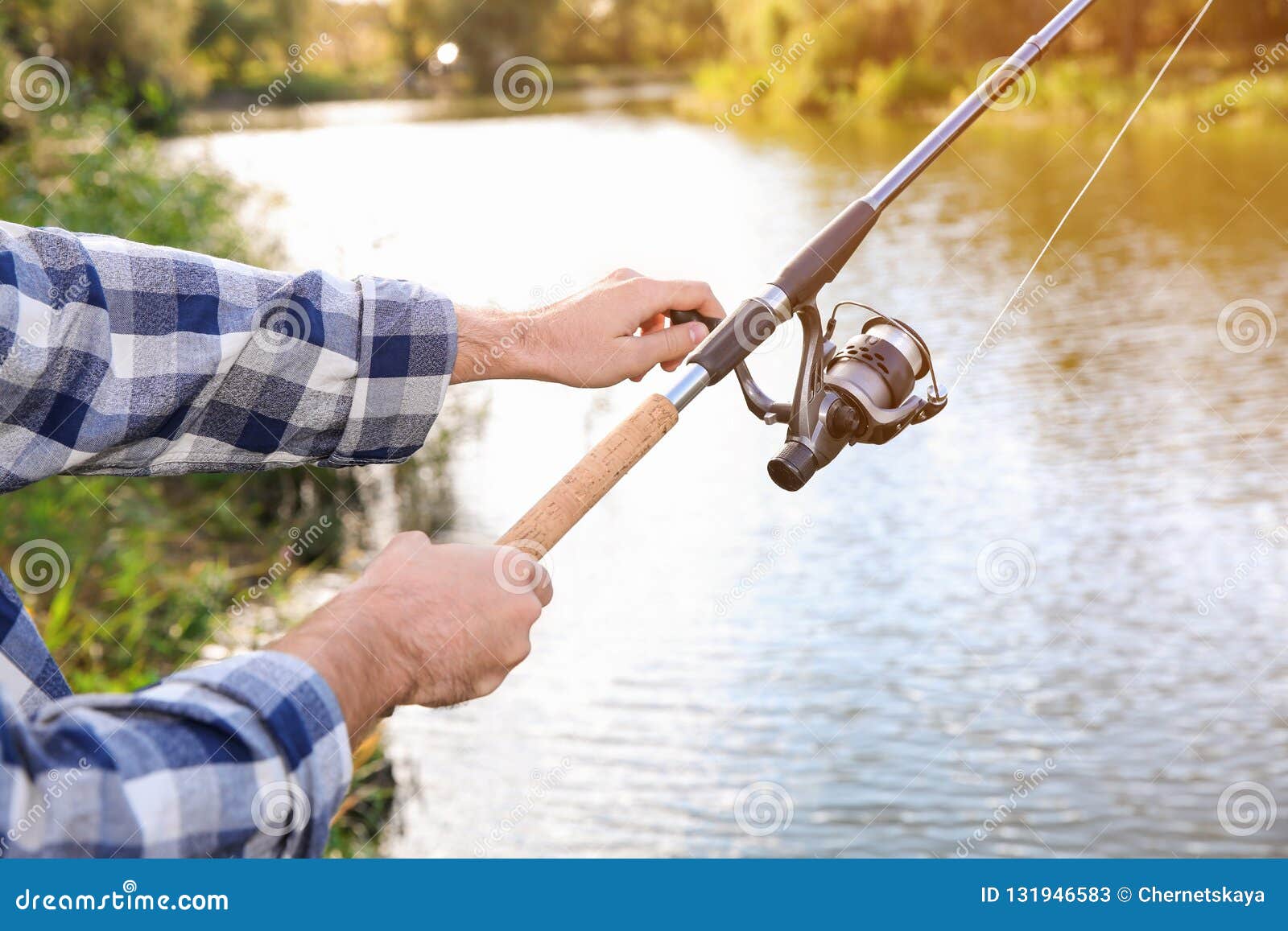 Man with Rod Fishing at Riverside, Focus on Hands Stock Image