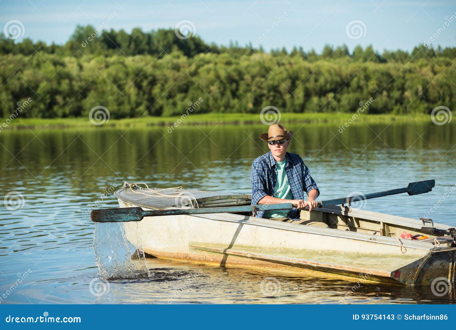 Man in a rowing boat. stock image. Image of sunglasses 93754143