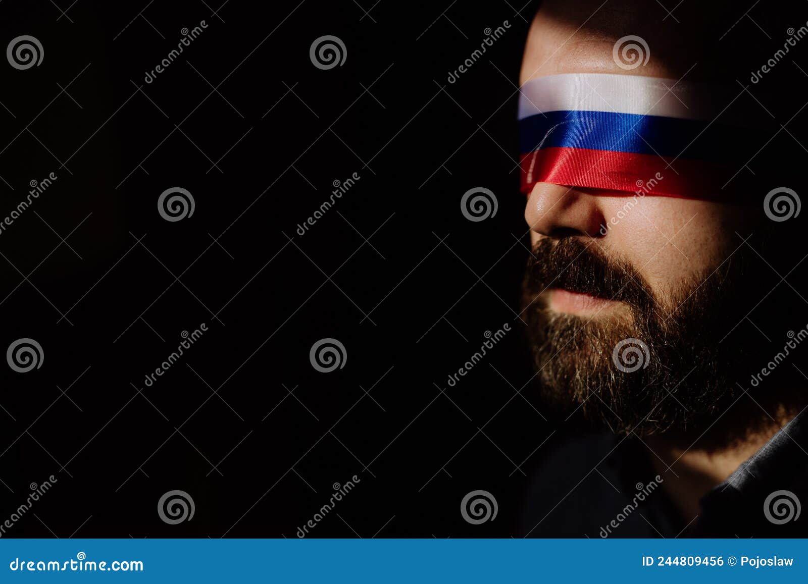 man with russian flag blindfold on black background, russian propaganda closed people& x27;s eyes concept.