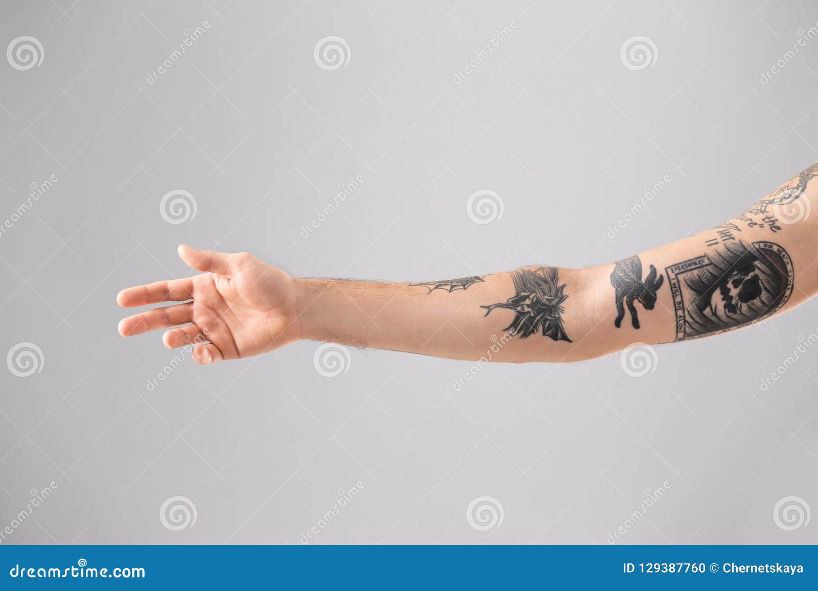 man s arm stylish tattoos man s arm stylish tattoos grey background 129387760