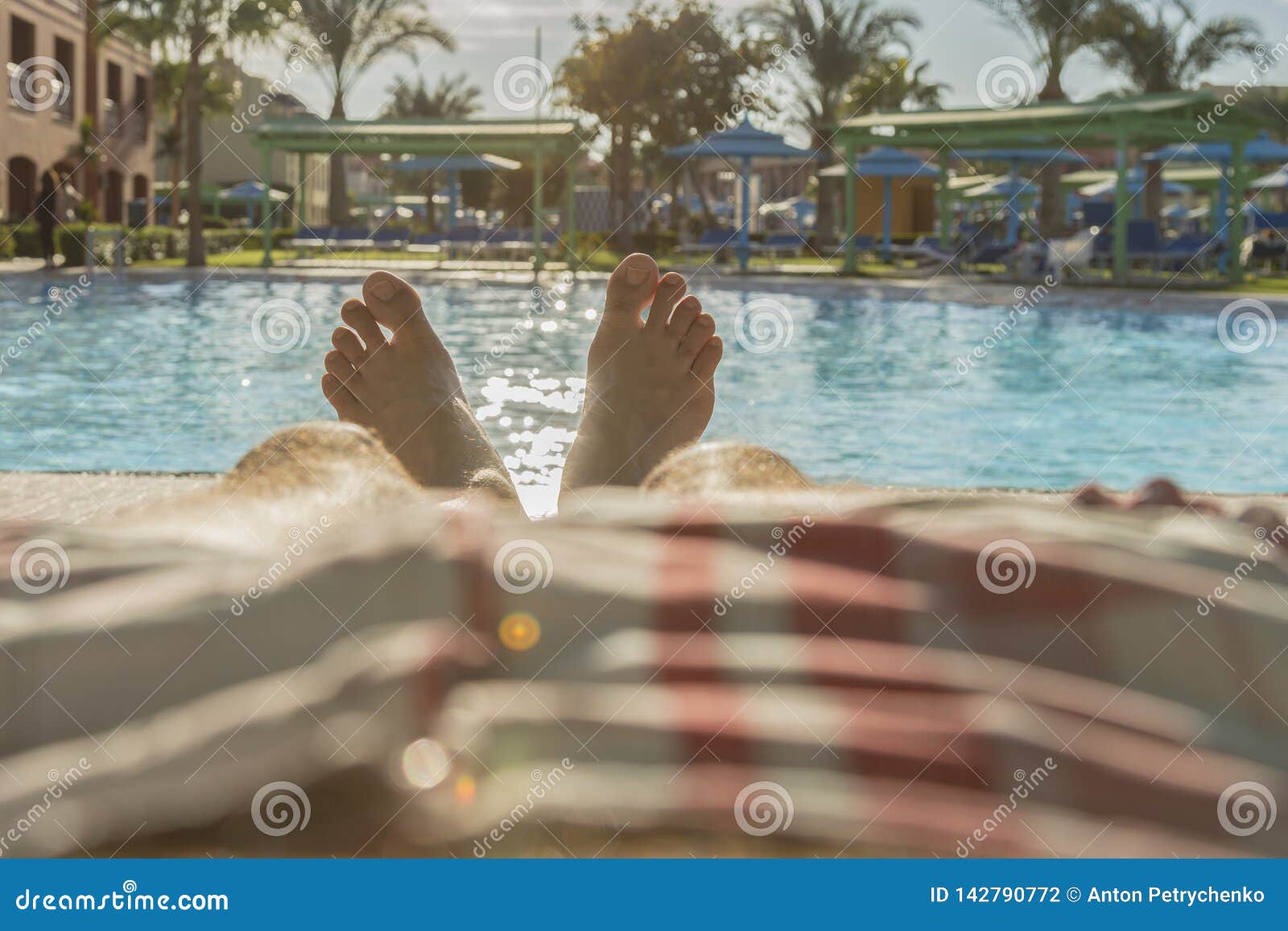 Man S Feet On The Background Of A Swimming Pool Man Relaxing By The Man S Feet On The Background Of A Swimming Pool Man Relaxing By The