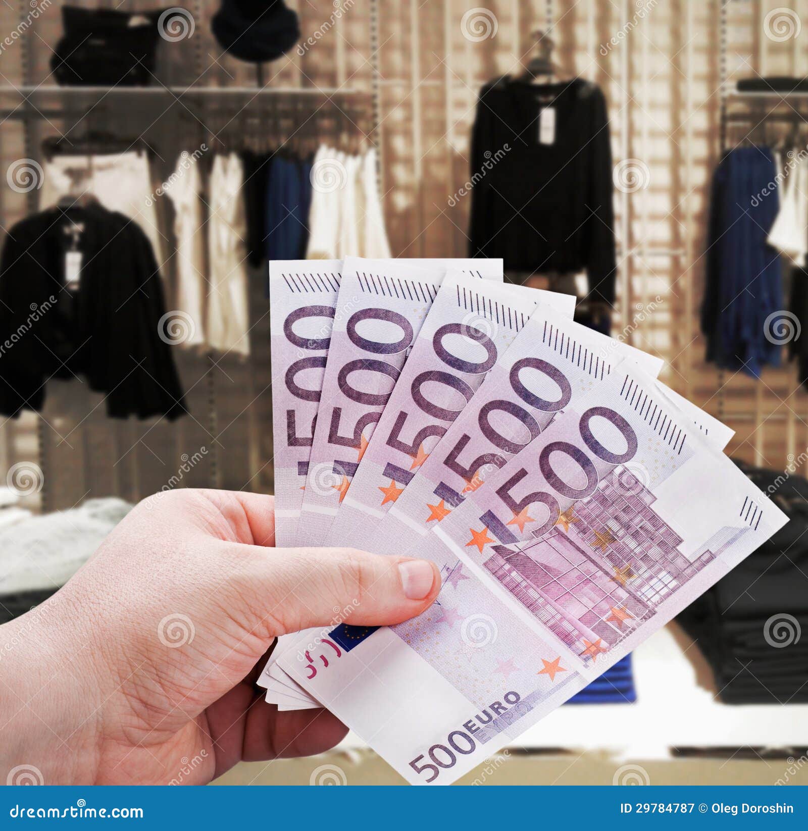 Hand holding euro to new shopping in the supermarket. Man s hand holding a euro to new shopping in the supermarket