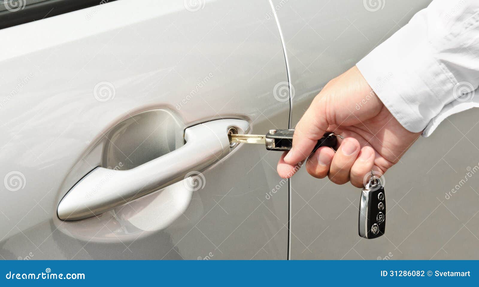 Man S Hand Inserting a Key into the Door Lock of a Car Stock Photo