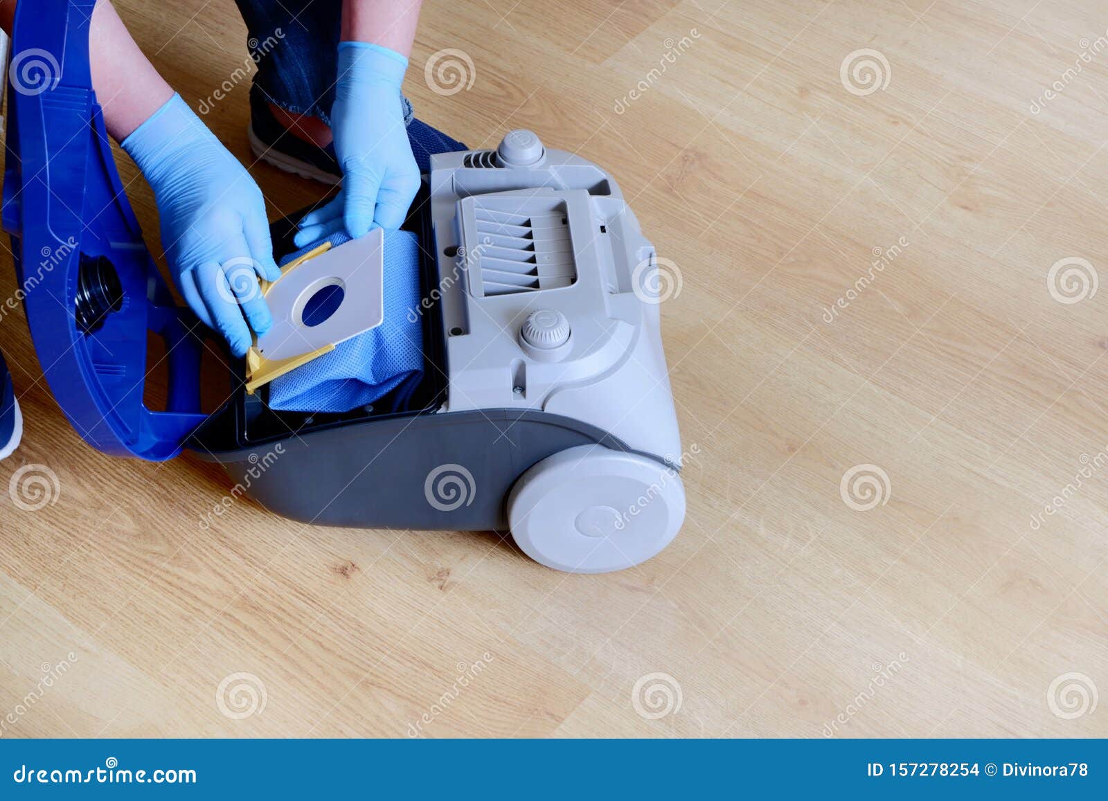 A Man`s Hand Installing a Clean Empty Dust Bag in a Vacuum Cleaner.Copy