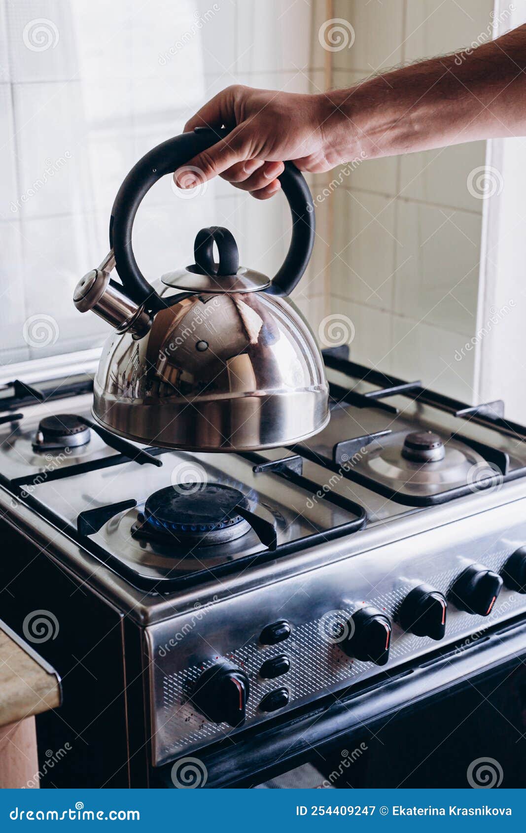 Man`s Hand Puts the Kettle on the Gas Burner Stock Image Image of