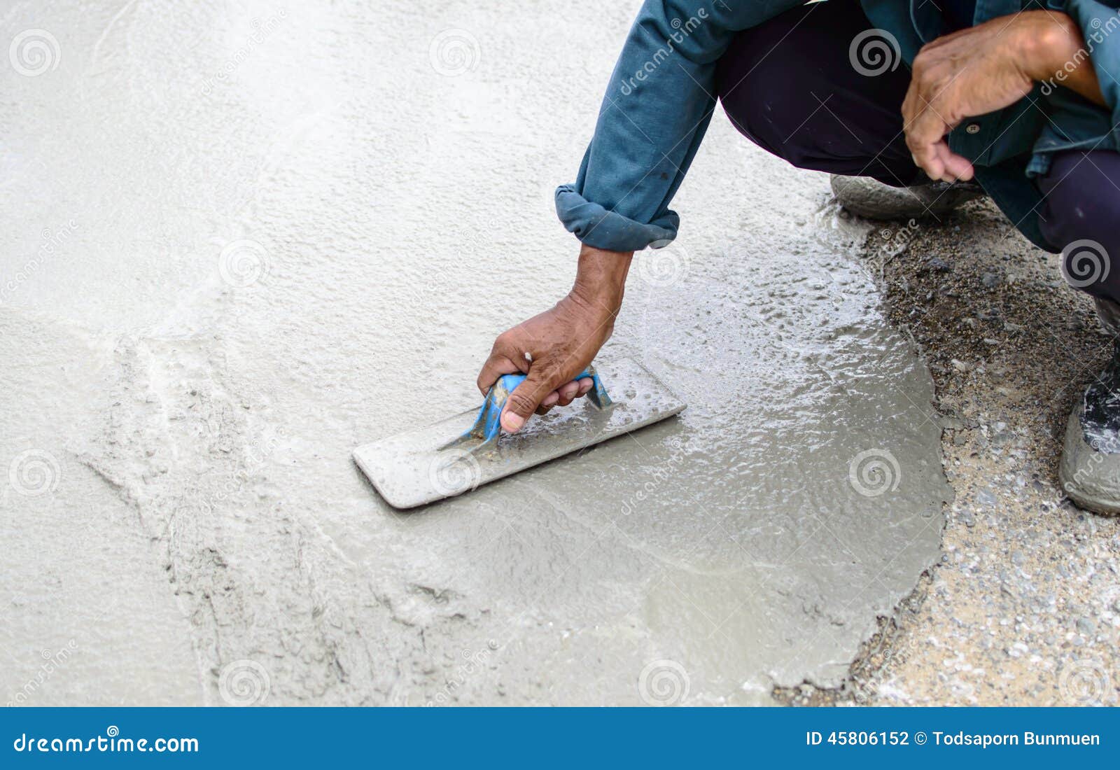 Man S Plastering a Floor with Trowel. Construction Worker Stock Photo
