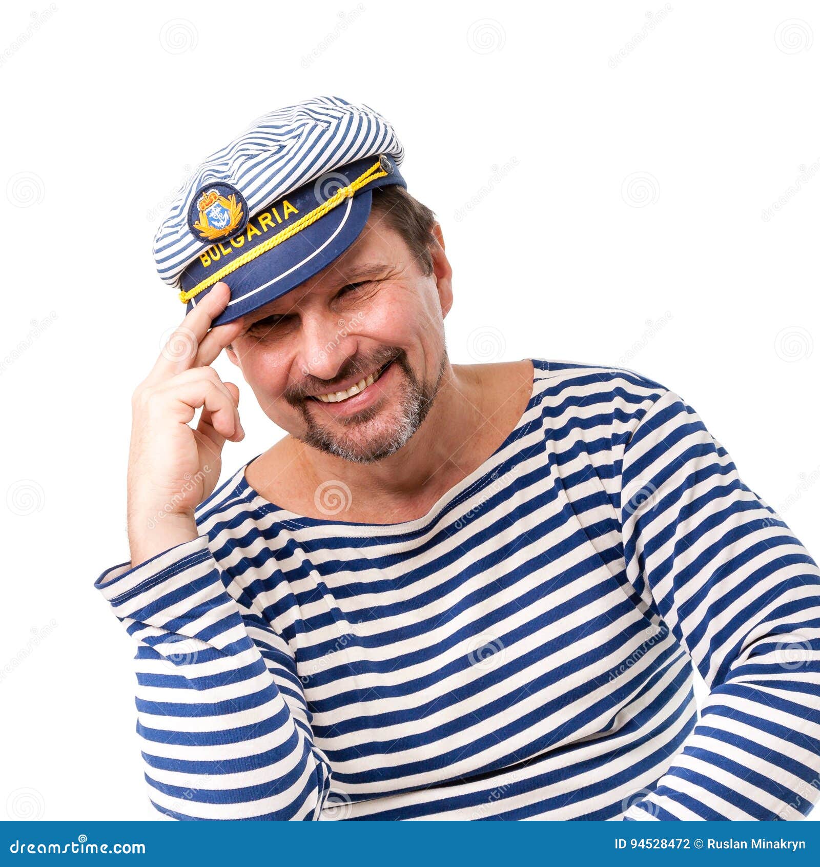 A Man Sailor in a Cap with a Smoking Pipe in Front of a White Ba Stock