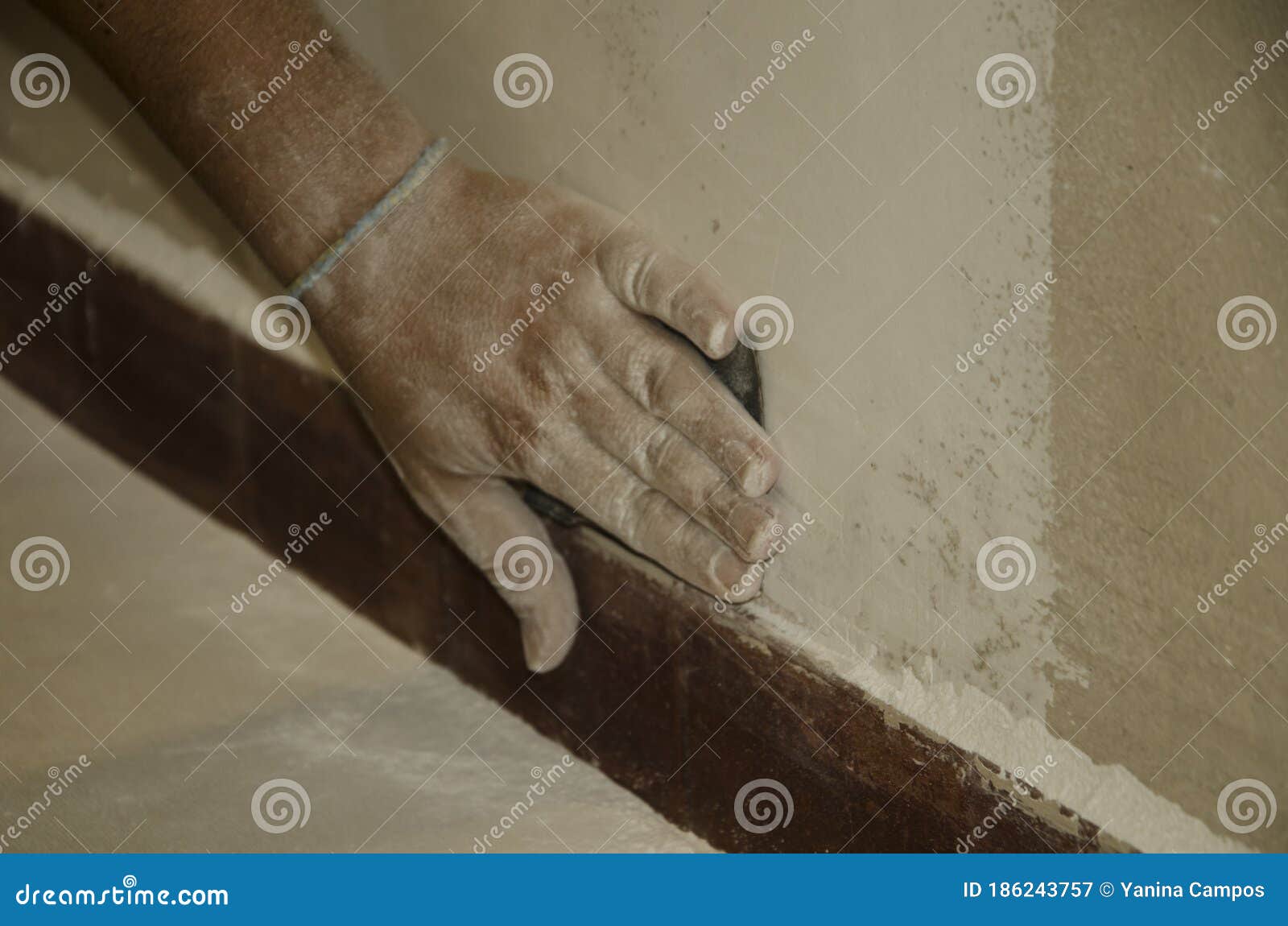 Man sanding a wall by hand stock image. Image of painter 186243757