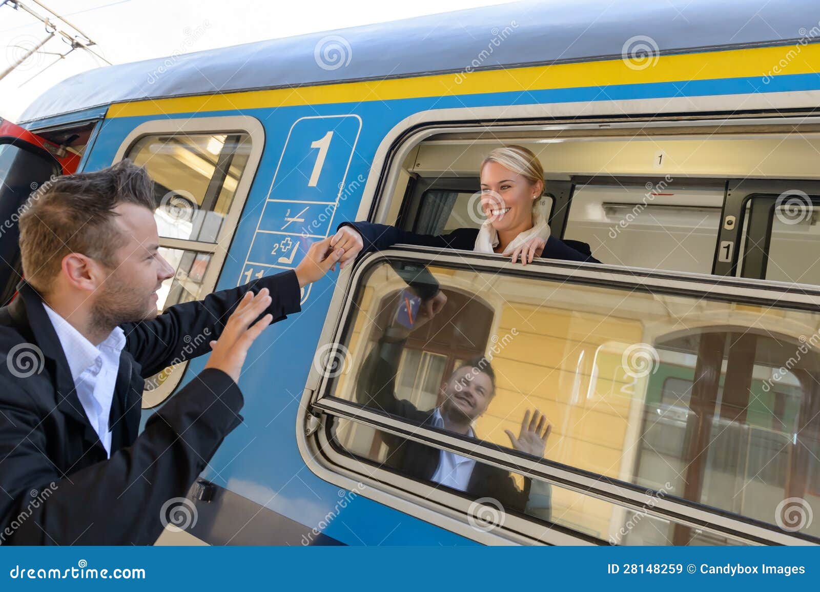 man saying goodbye to woman on train
