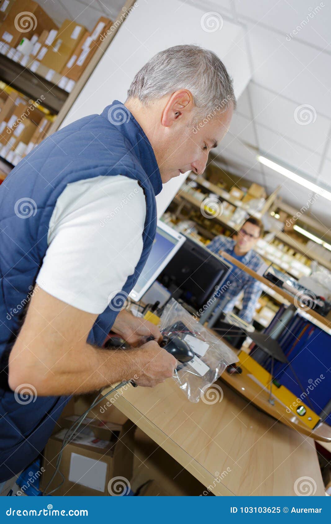 man scanning producto with handheld device