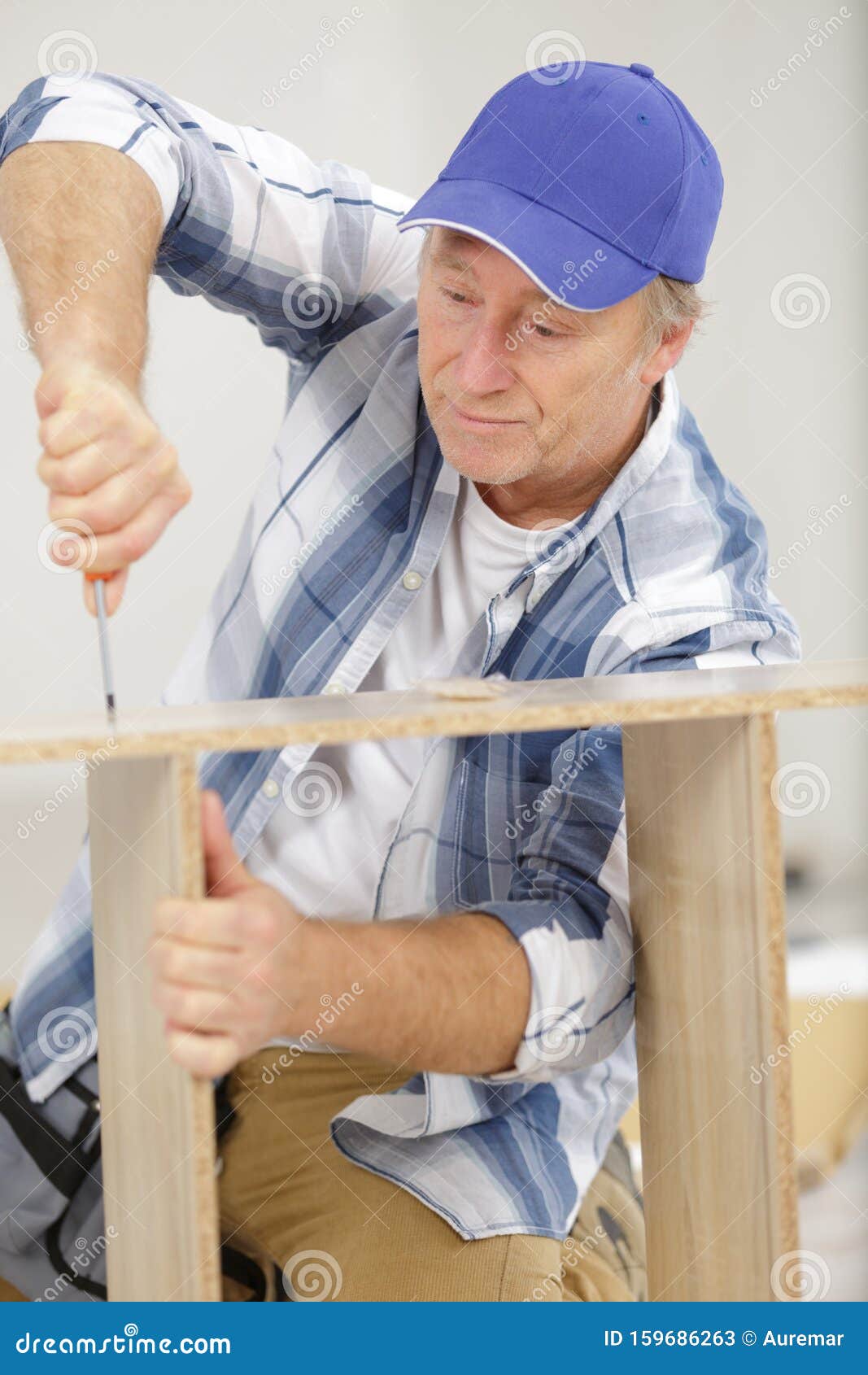 Man screwing into wood stock image. Image of business 159686263