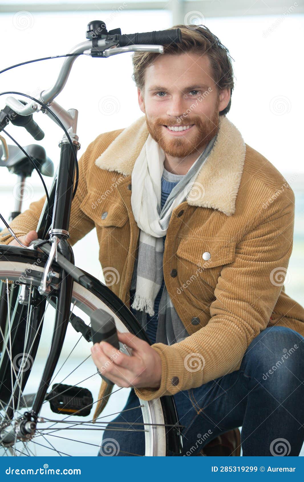 Man Securing Lock on Front Wheel Bicycle Stock Image Image of steel