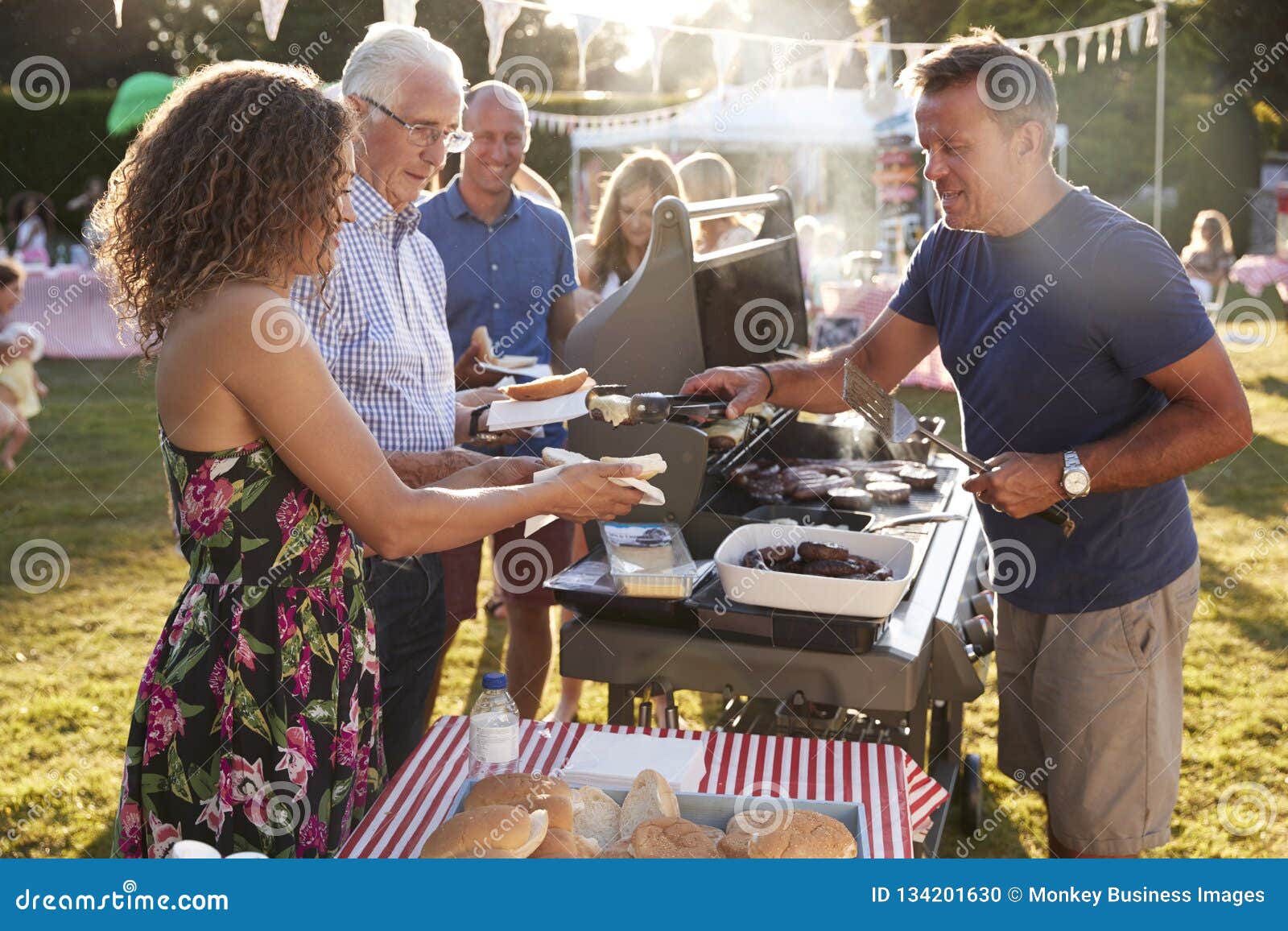 Man Serving on Barbeque Stall at Summer Garden Fete Stock Photo - Image ...