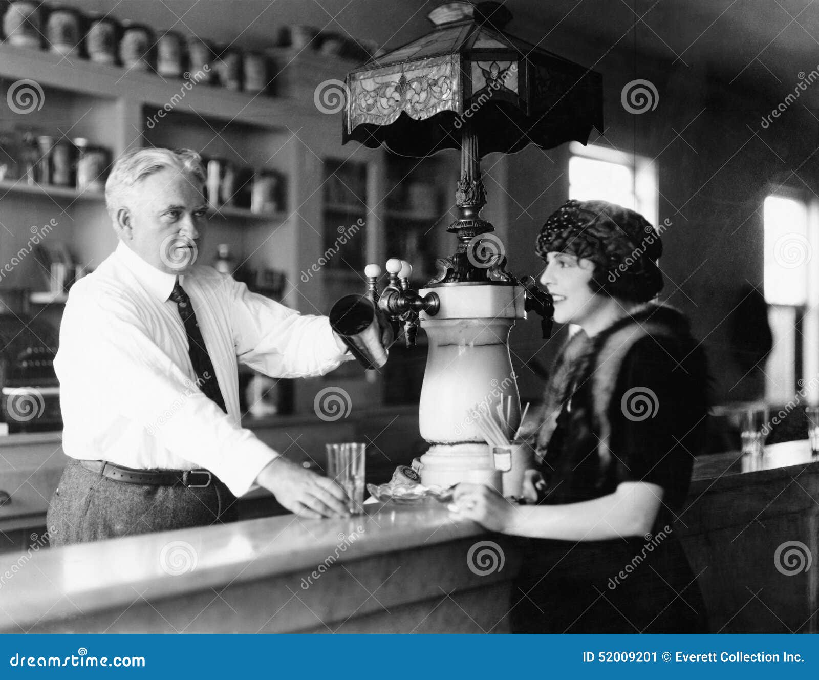 Man Serving Beverage To Woman at Counter Stock Image Image of