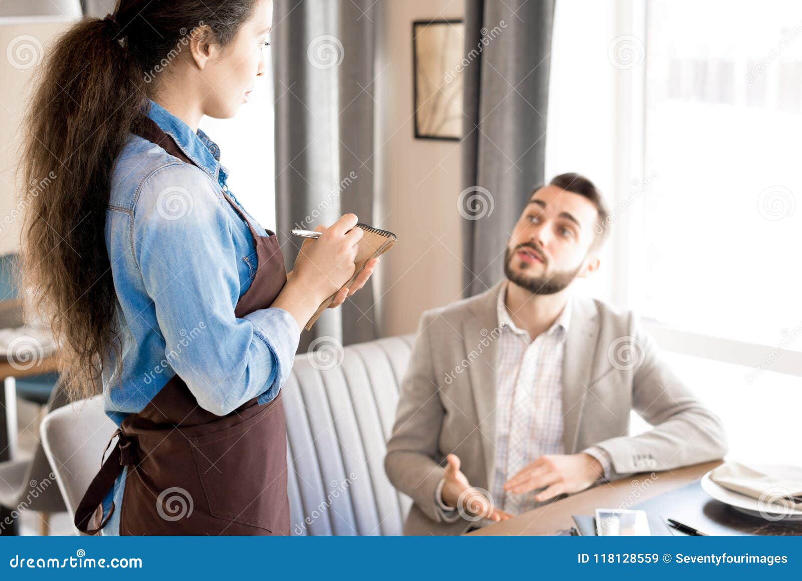 Man Sharing His Taste Preference With Waitress Stock Image
