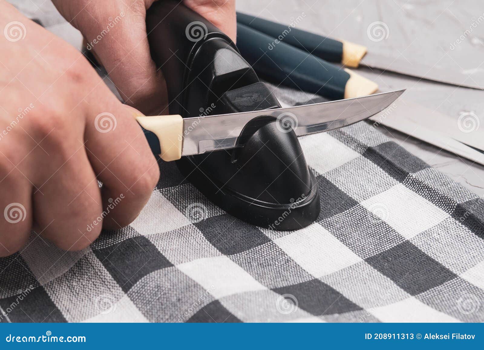 Man Manually Sharpens Kitchen Knives. Knife Sharpening. the Concept of