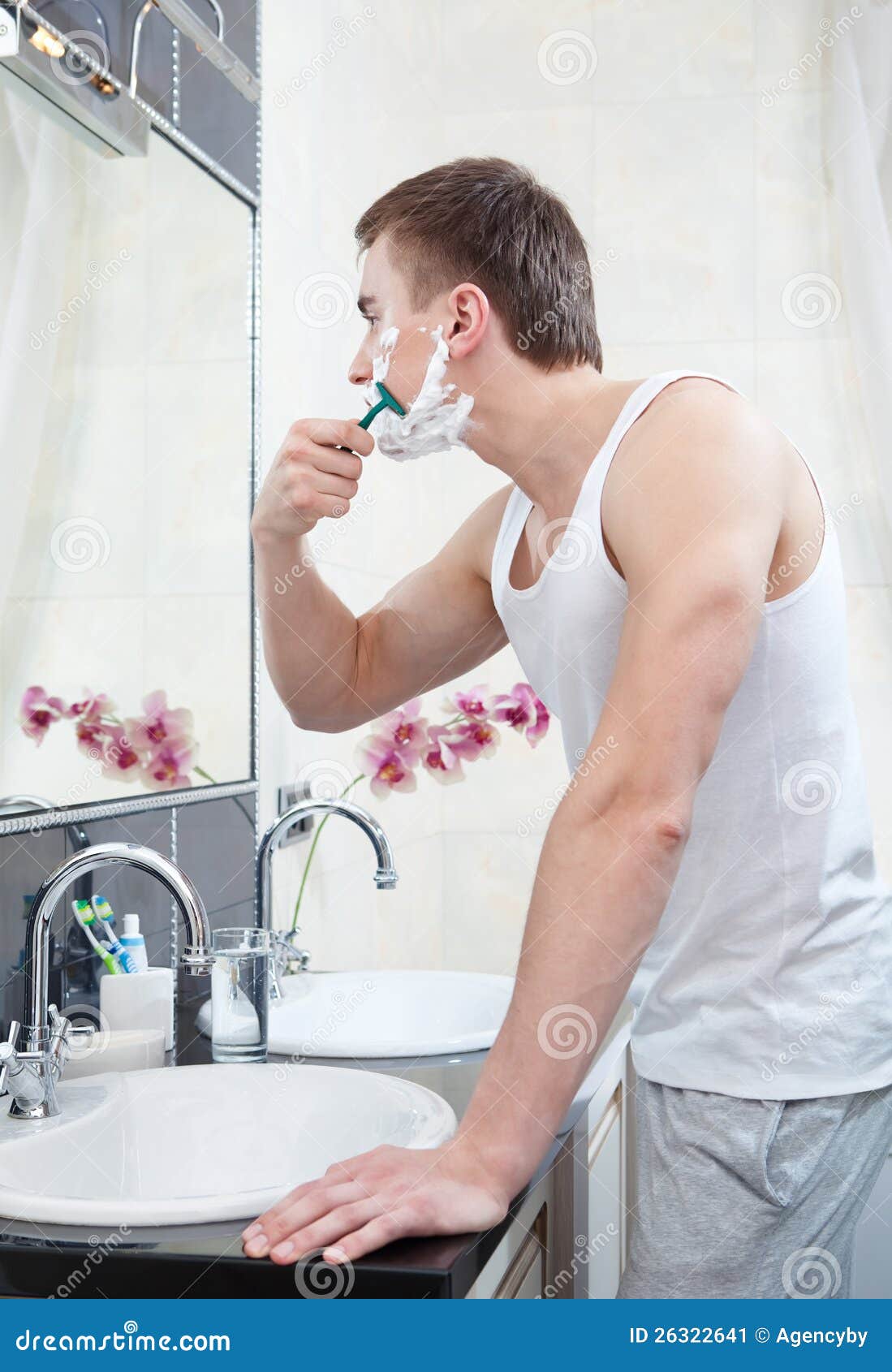 Man shaves in the bathroom stock image. Image of pajamas 26322641