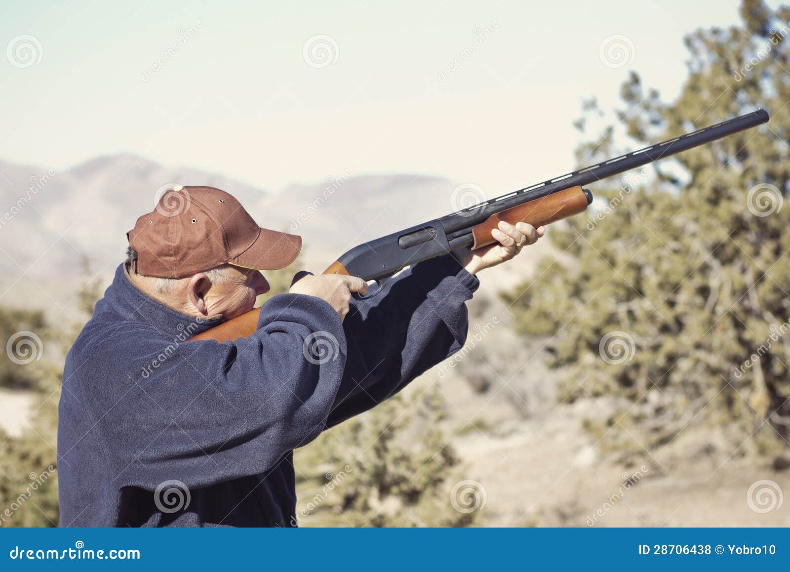 man shooting a shotgun hunting