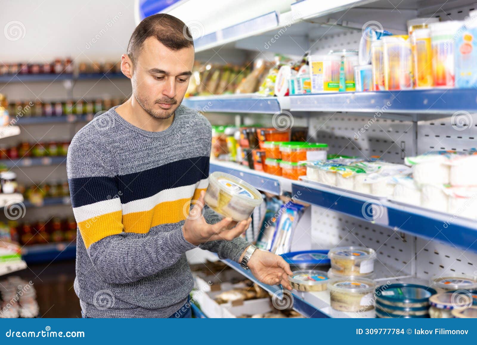 Man Shopper Carefully Selects Salted Herring in Grocery Store Stock Photo Image of shop