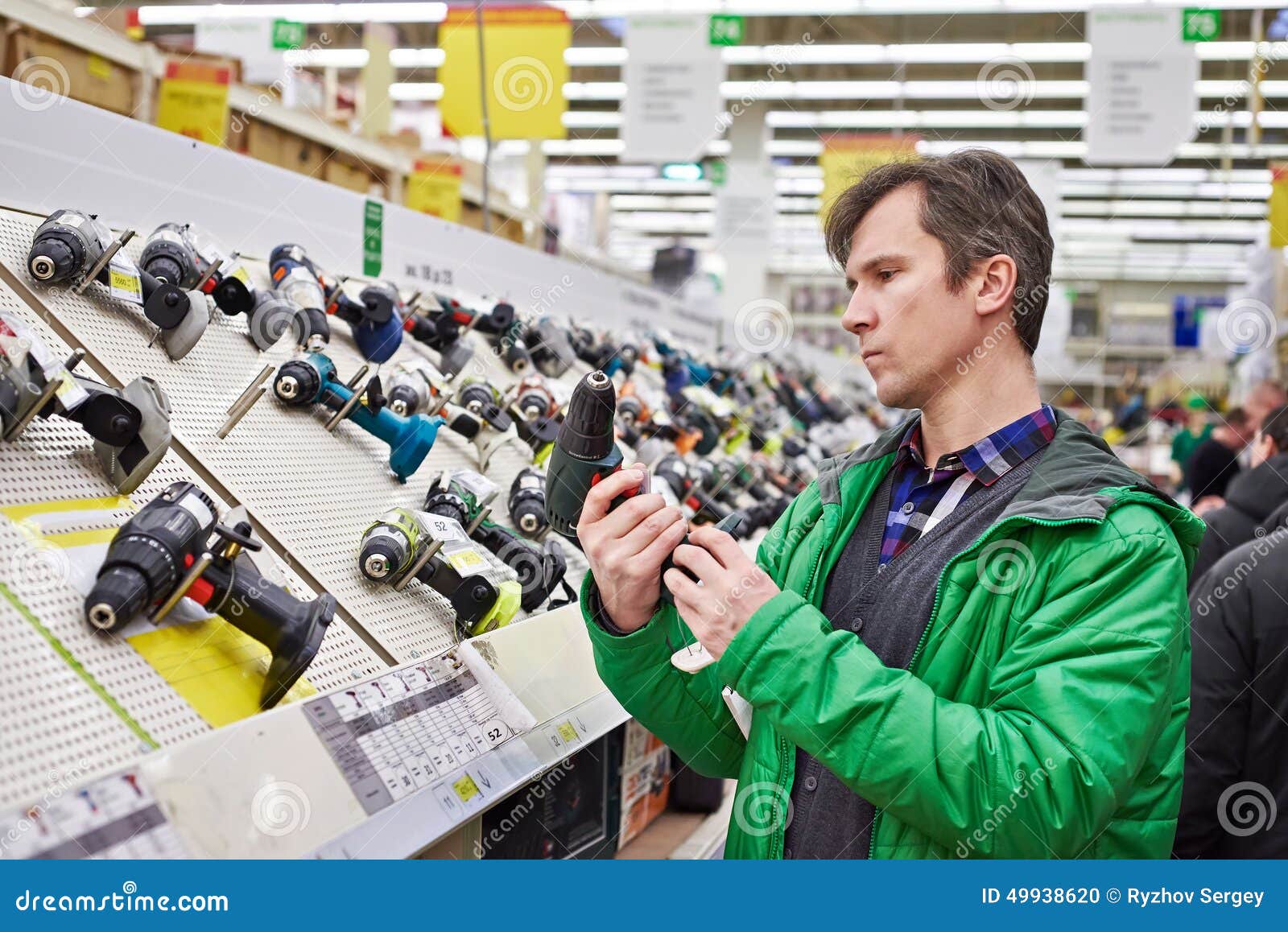 man shopping for screwdriver in hardware store