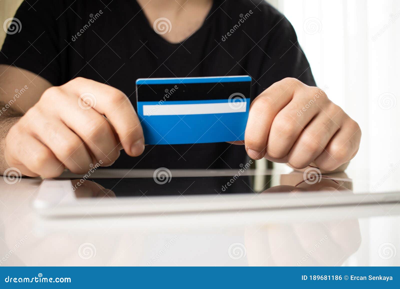 man holding tablet pc and credit card indoor, shopping online