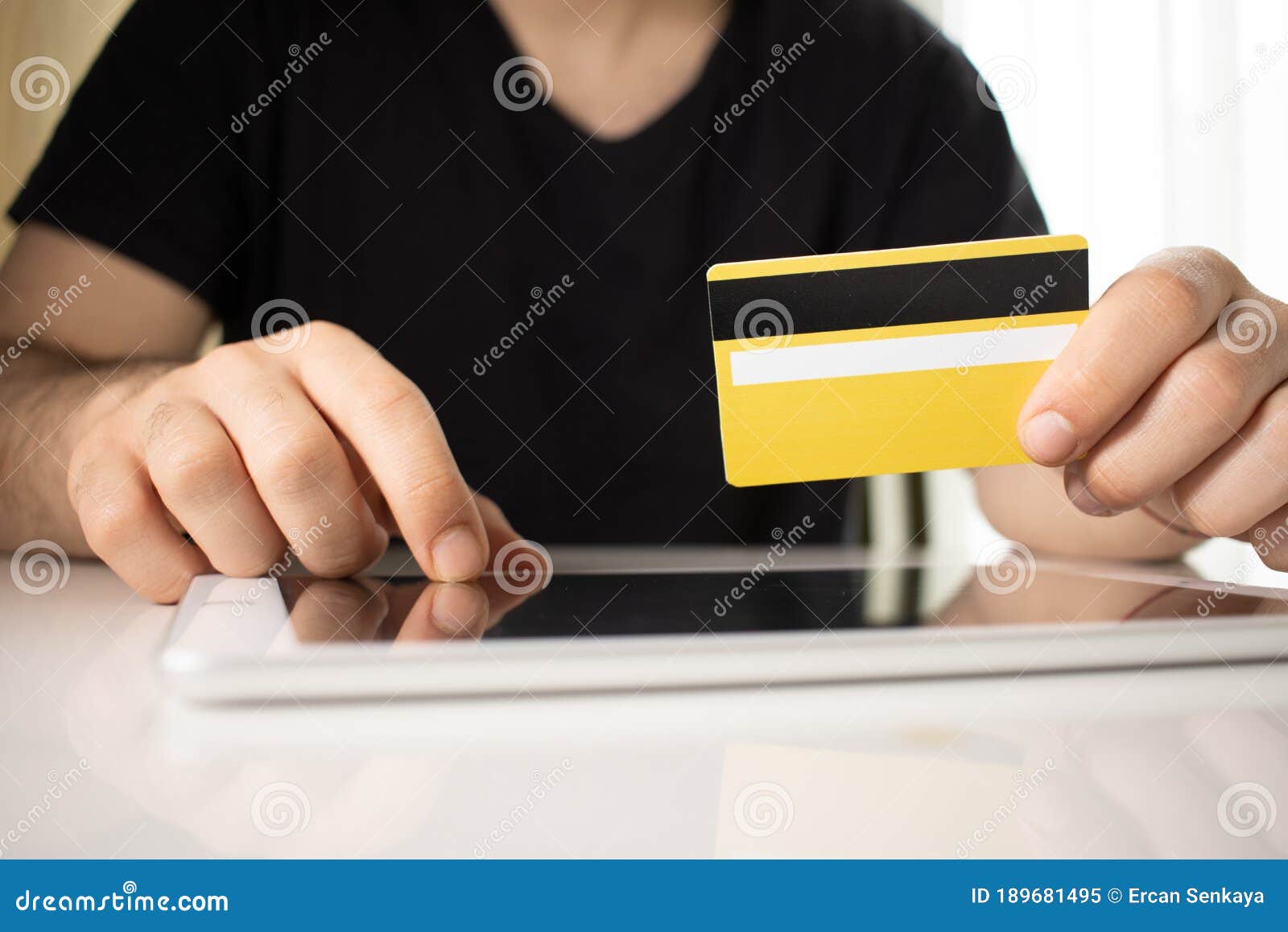 man holding tablet pc and credit card indoor, shopping online