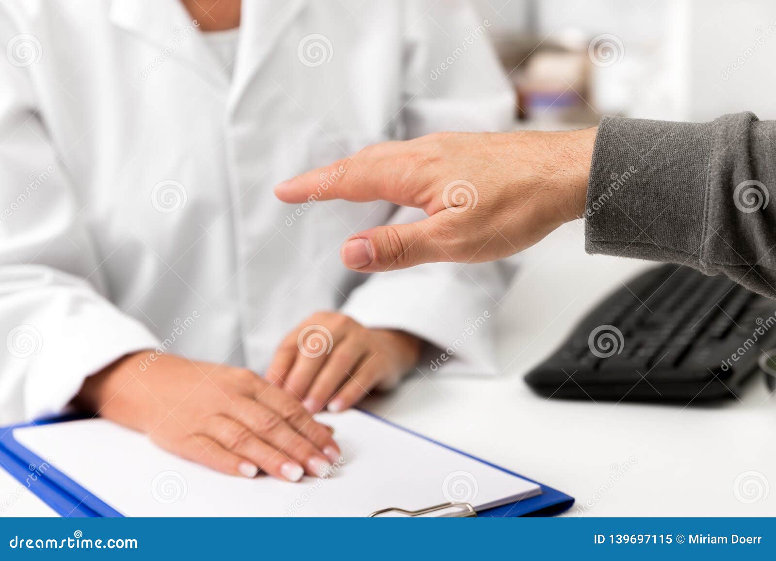 man showing his tremulous hand on the clinic, concept tremor, parkinson and stress