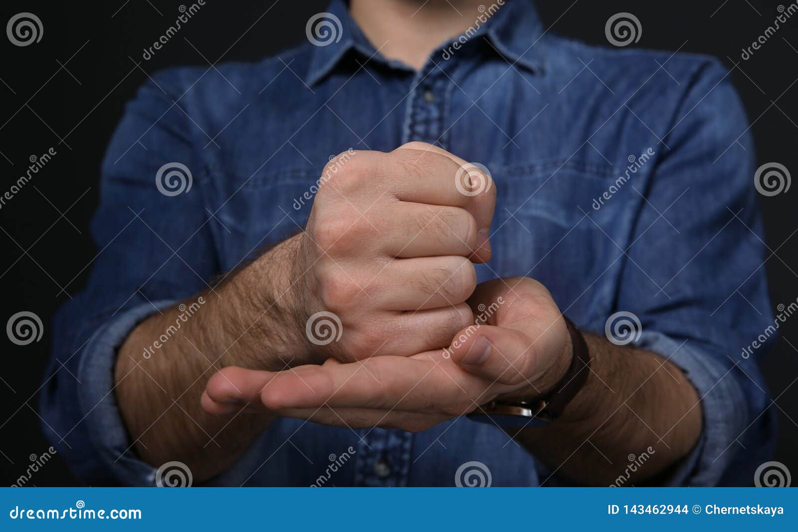 man showing word crucify in sign language on black background