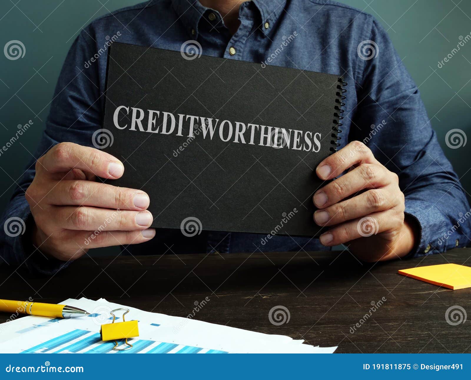 the man shows an sign creditworthiness on a black page.