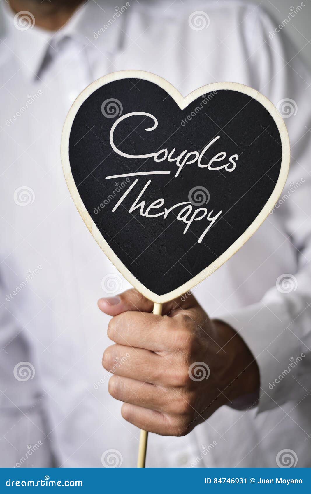 man with signboard with text couples therapy