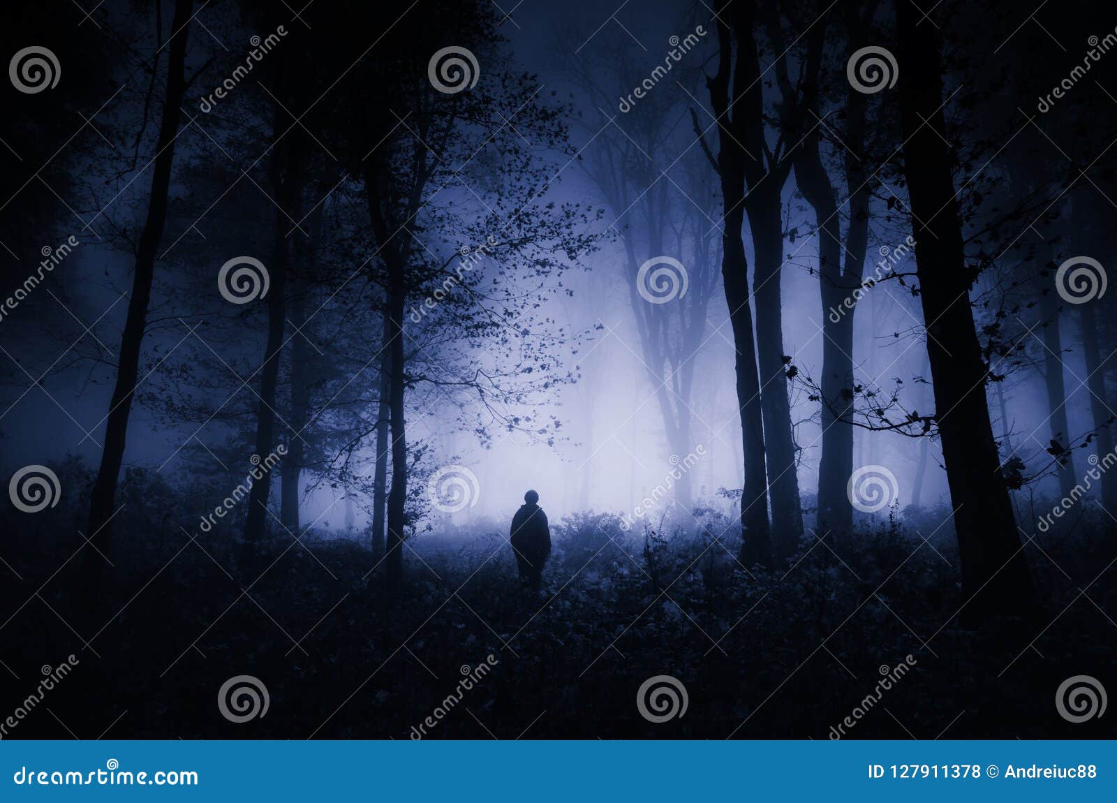 man in dark haunted woods