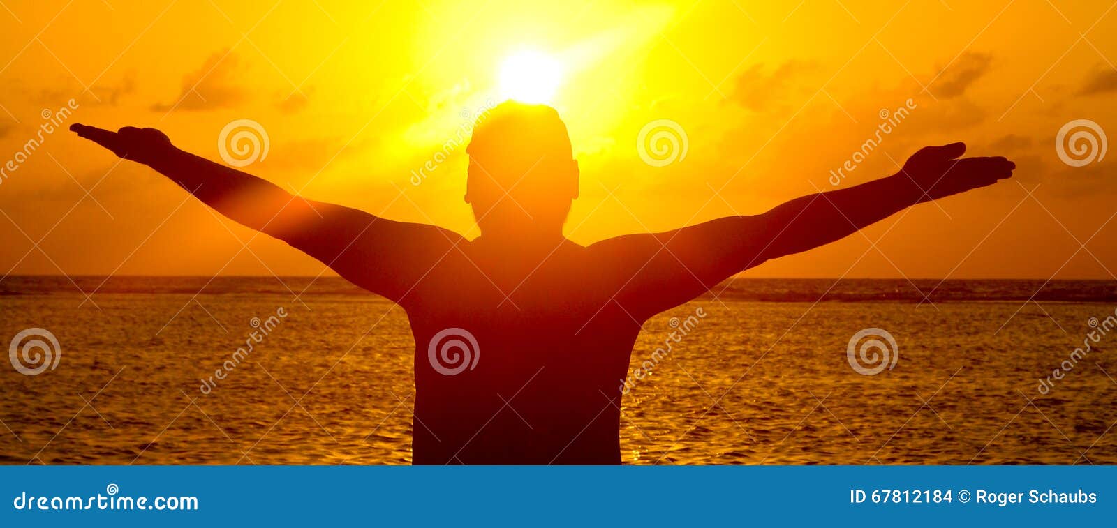man silhouette of outstretched arms in sunset