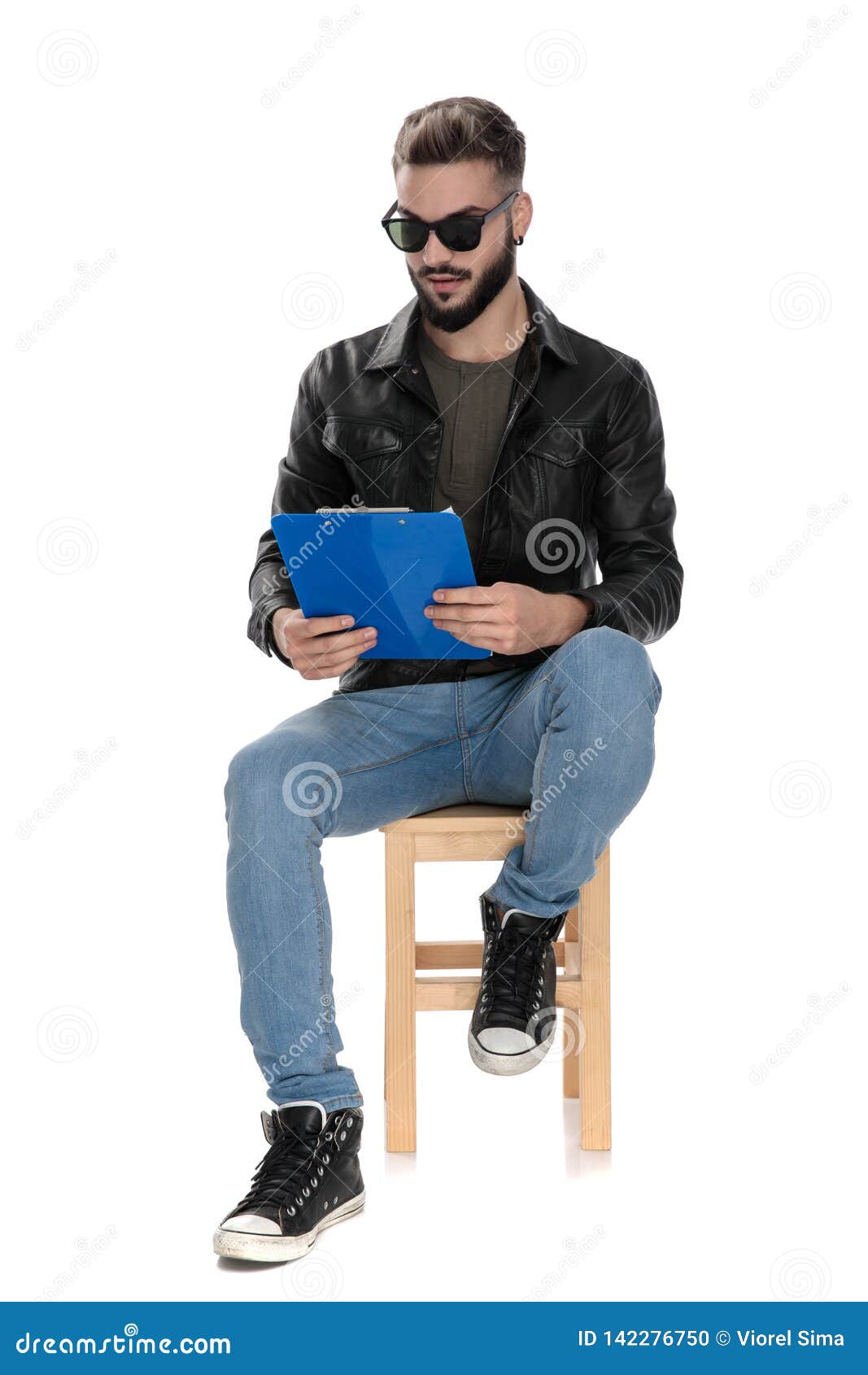 Man Sitting on Chair and Reading from Blue Folder Stock Photo - Image ...