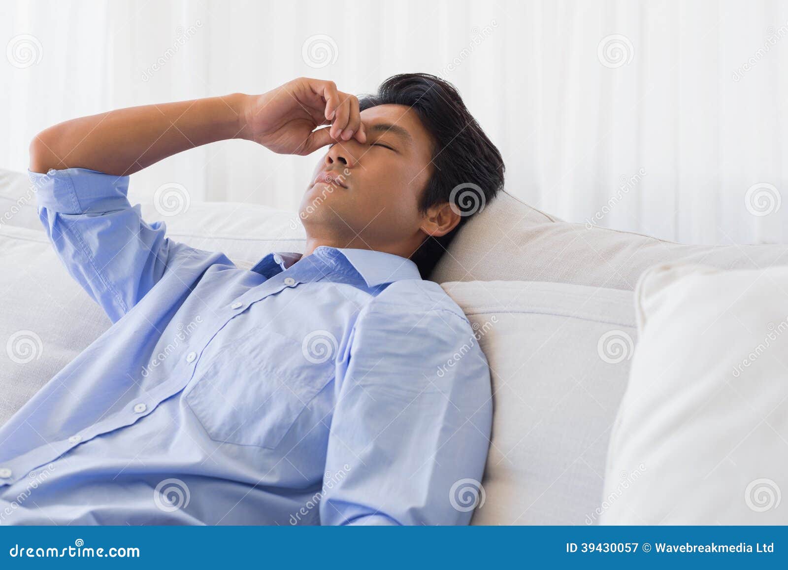 Man Sitting on Couch with a Headache Stock Image Image of pain