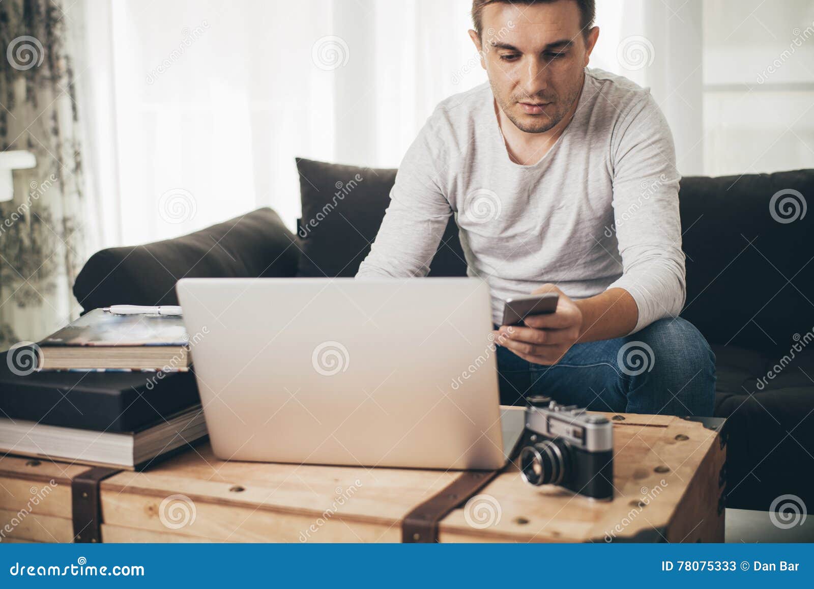 Man Sitting on a Sofa Working on Laptop Stock Image Image of business