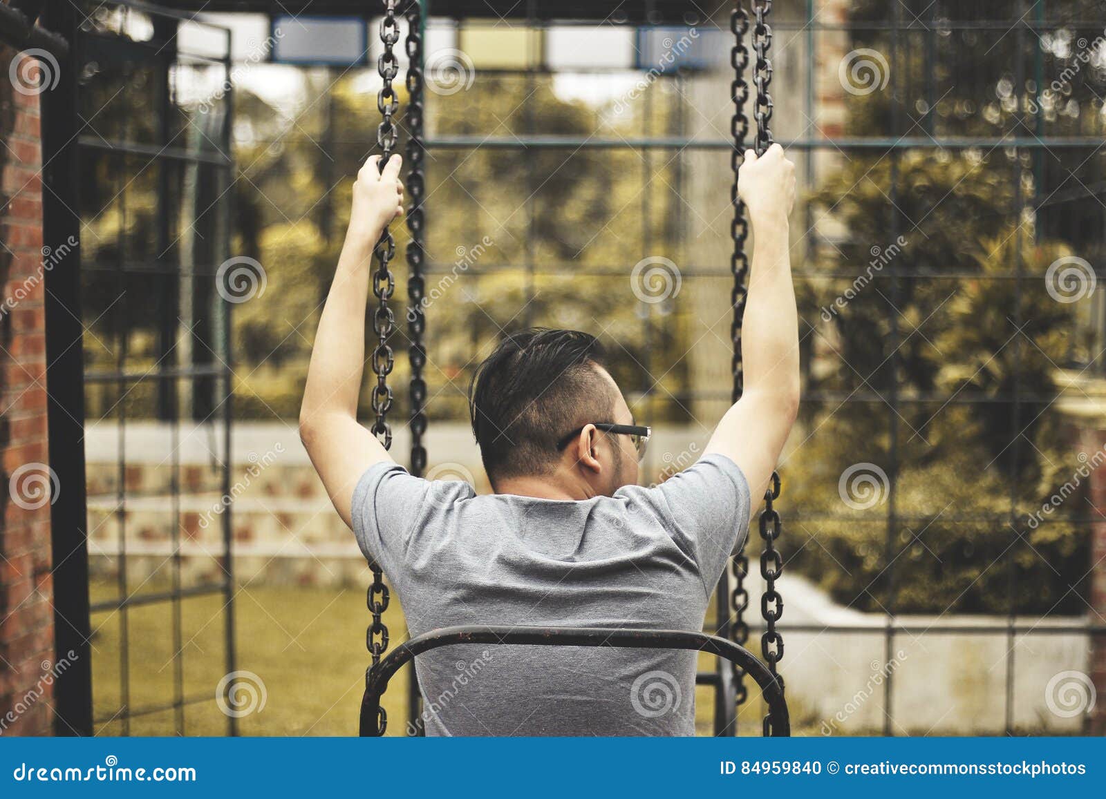 Man Sitting On Swing Picture. Image 84959840
