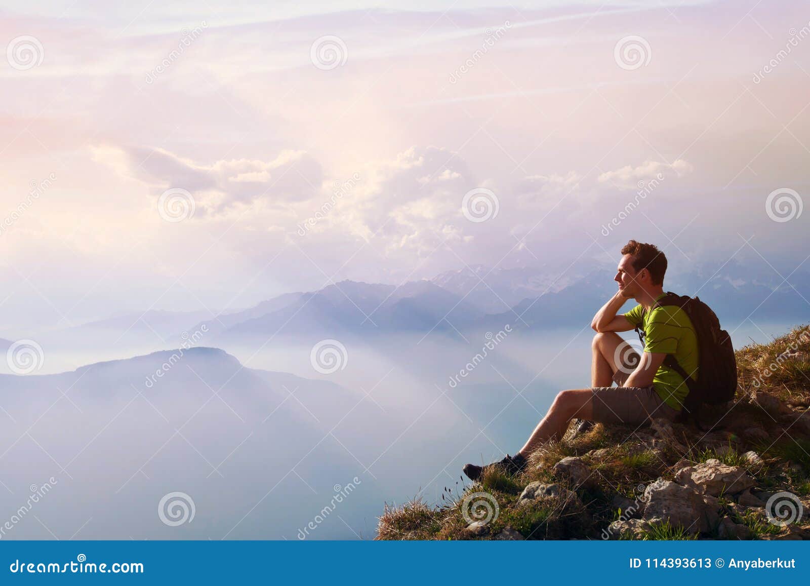 man sitting on top of mountain, achievement or opportunity concept, hiker