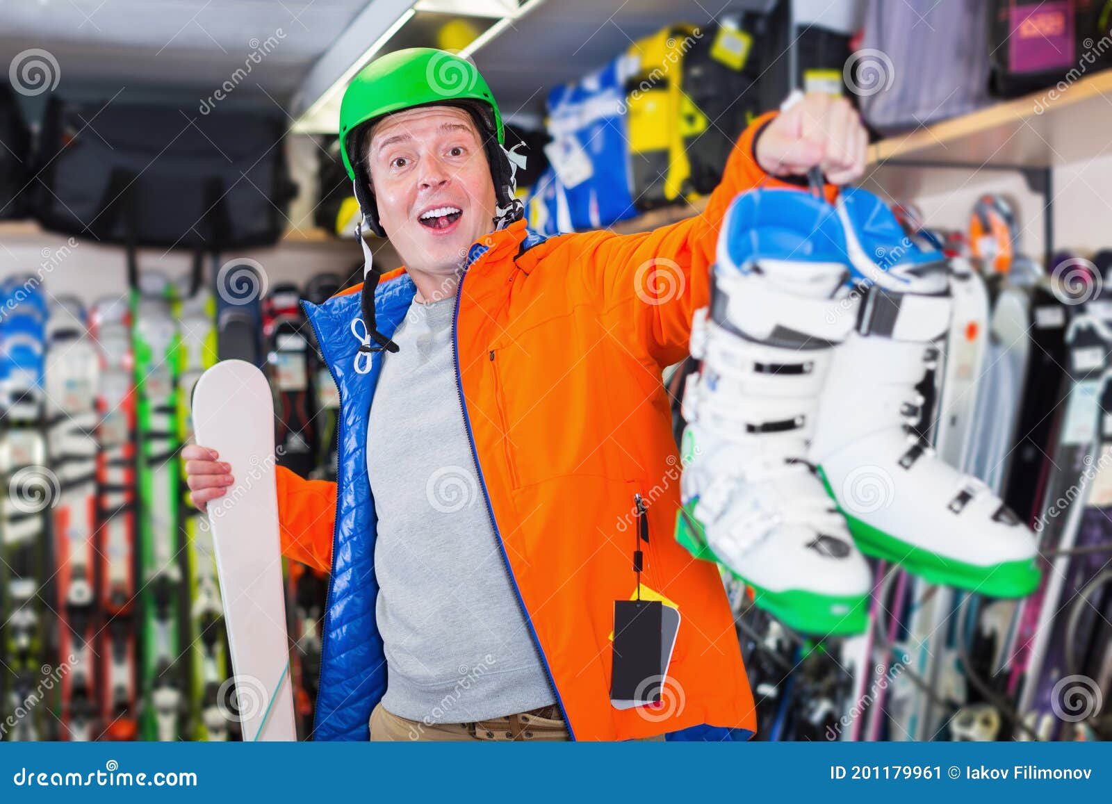 Man in Ski Equipment is Demonstrating Boots for Skiing Stock Image