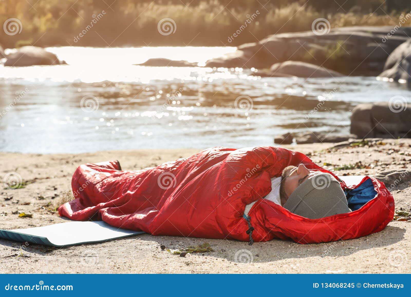 Man in Sleeping Bag on Wild Beach Stock Image - Image of professional ...