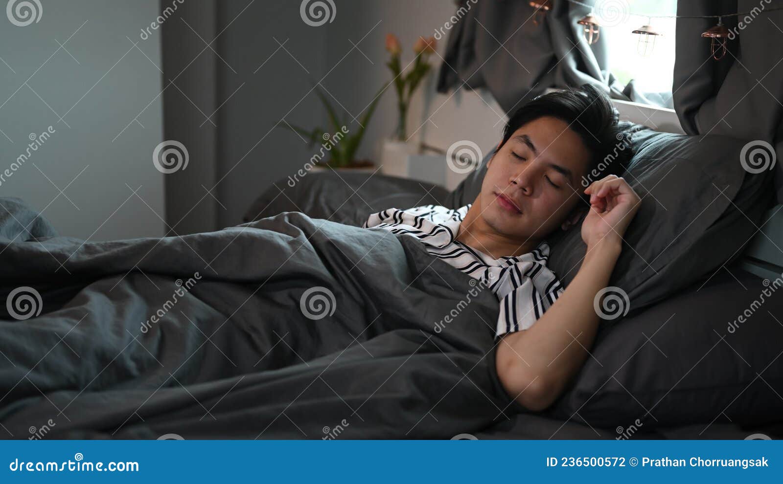 man sleeping in his comfortable bed after tiring day.